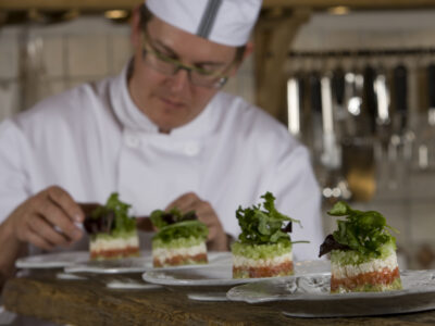 A chef preparing dish presentation