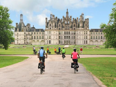 Cycling in front of the Château of Chambord in the Loire Valley