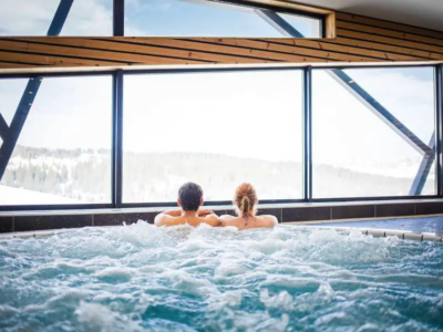 A couple enjoying a spa overlooking the mountains