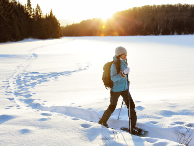 A lady walking with snowshoes in nature