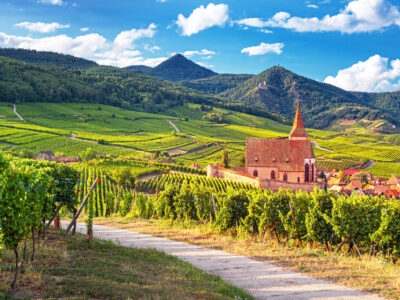 Scenic view on church and Hunawihr wine village in the middle of vineyards of Alsace region, France