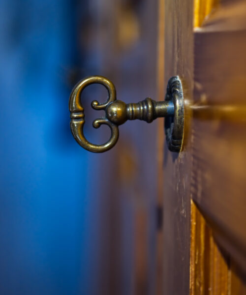 Old and mysterious key in a key hole of an old door