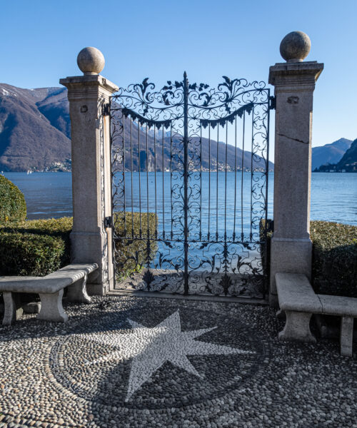 Beautiful gates leading to a private dock on a lake in the Alps