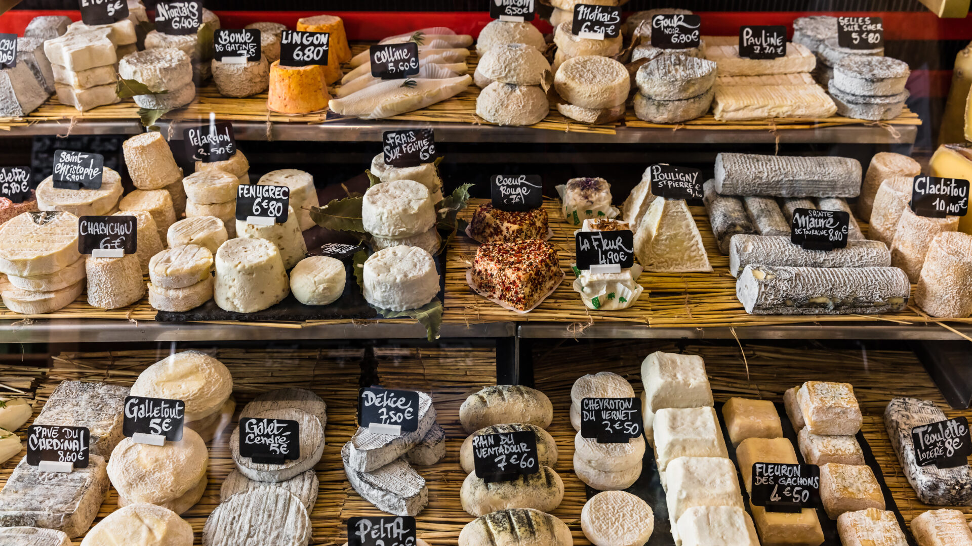 A cheese presentation with lots of varieties on a market stand