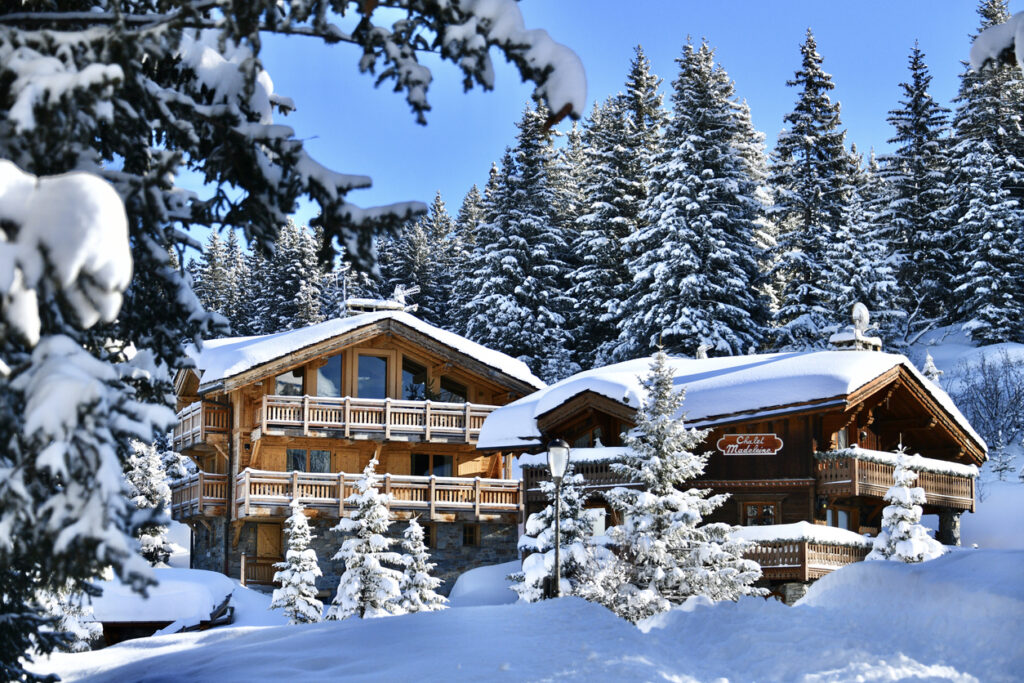 Exclusive private chalet in Courchevel featuring traditional Alpine architecture and snowy surroundings